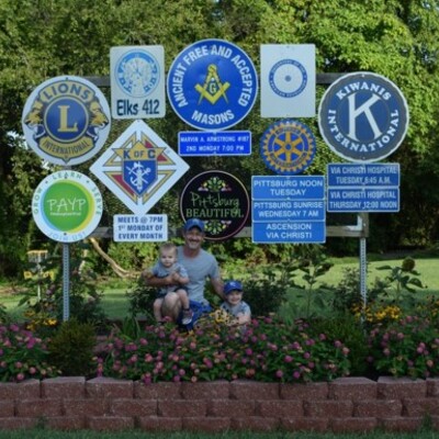 Volunteer Matt O'Malley and his family plant and maintain this organization sign on East 4th St.